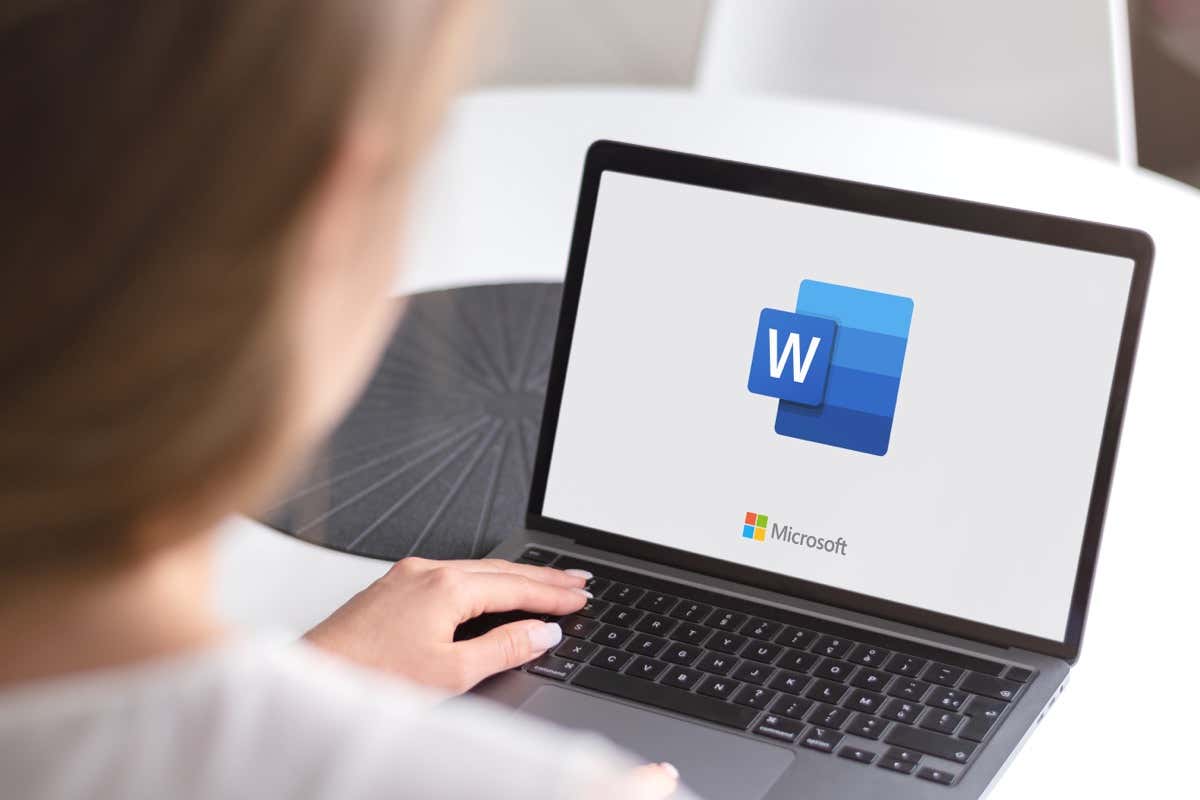 A person using a laptop with the Word document logo visible on the screen, showcasing image.