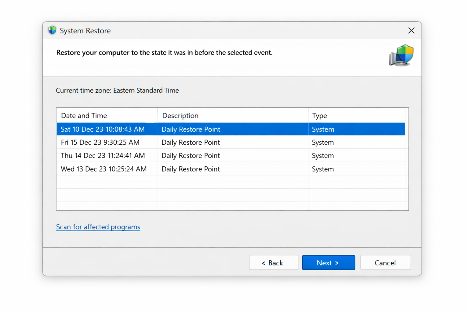System Restore window showing a list of restore points with dates and descriptions, with one restore point selected