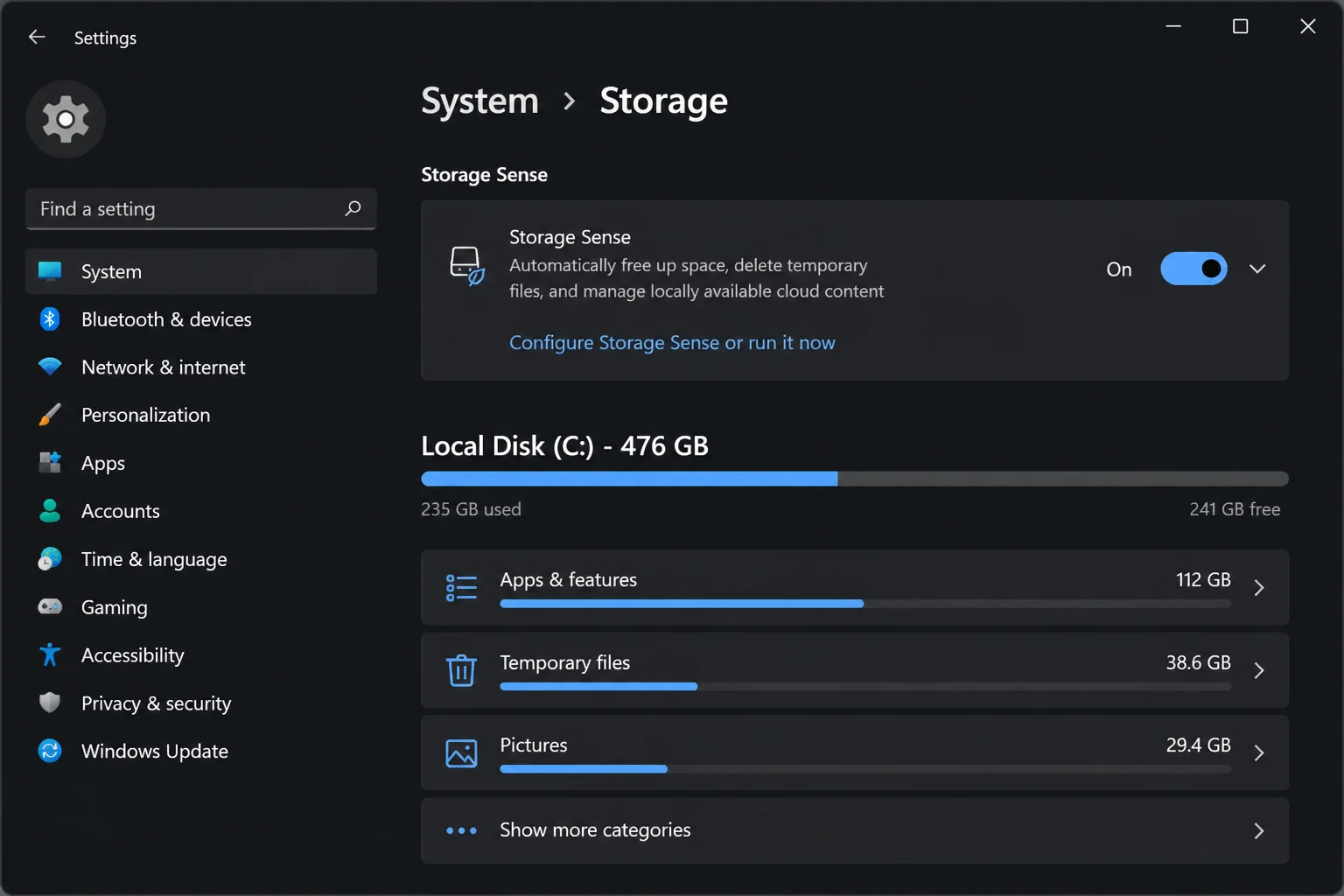 Windows 11 Settings > System > Storage page showing the Storage Sense toggle switch and "Configure Storage Sense or run it