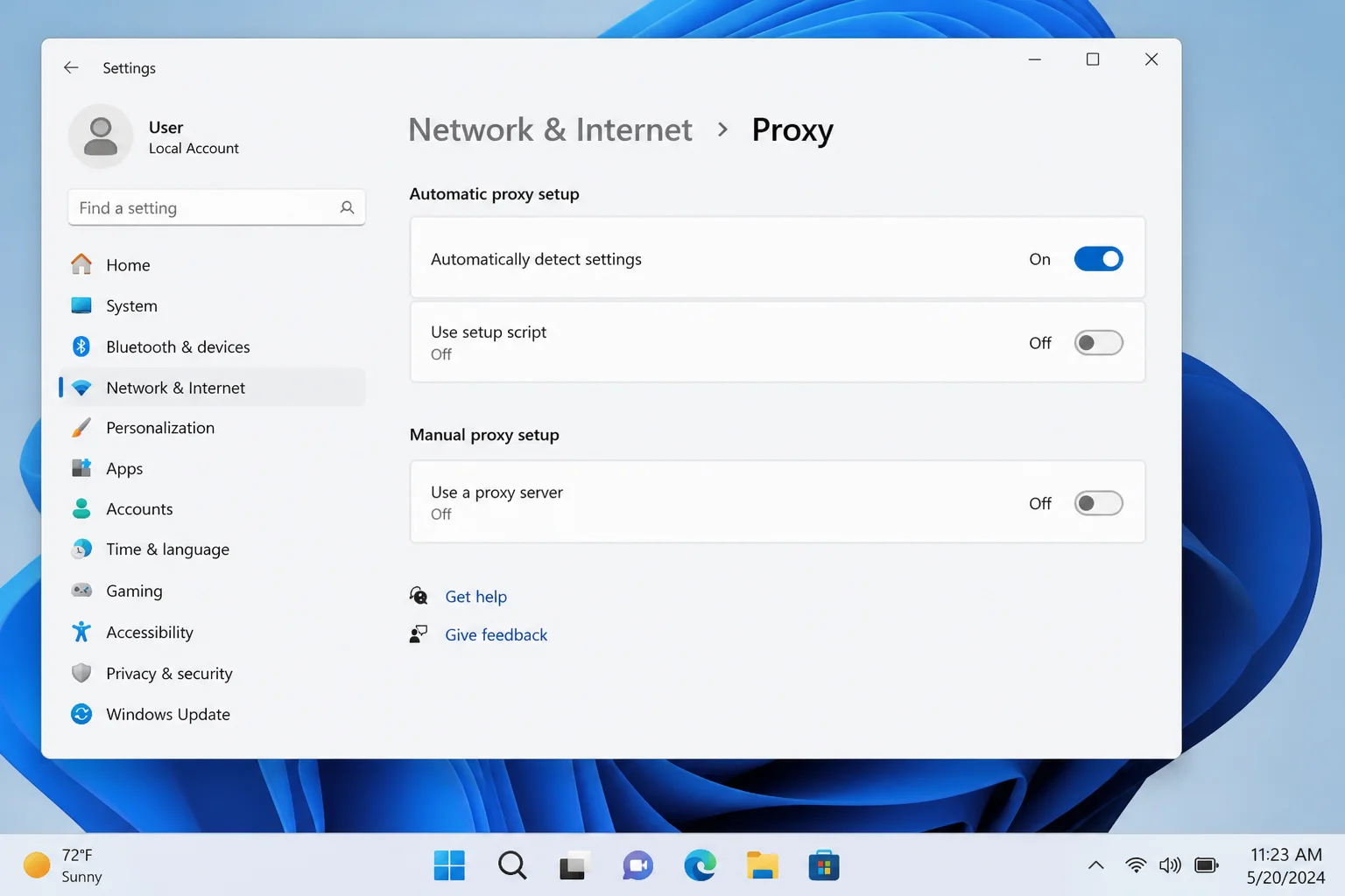 Windows 11 Settings > Network & Internet > Proxy with the Manual proxy setup section and "Use a proxy server" toggle set to