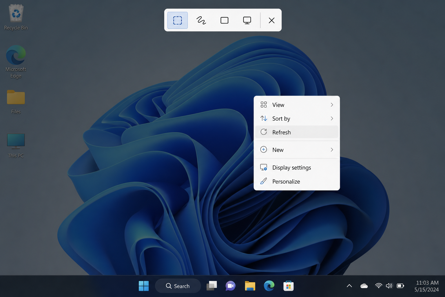 Windows 11 screen dimmed with the Snipping Tool snip toolbar visible at the top, showing Rectangular, Freeform, Window, and Fullscreen snip mode icons, with a right-click context menu still visible on the desktop below