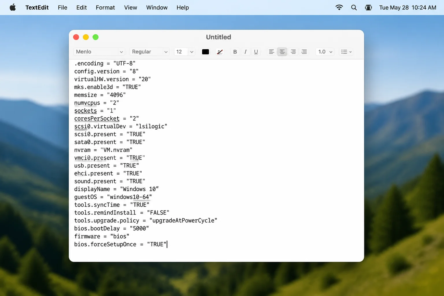 A .vmx config file open in TextEdit with the line bios.forceSetupOnce = "TRUE" added as the last line, with other VMX