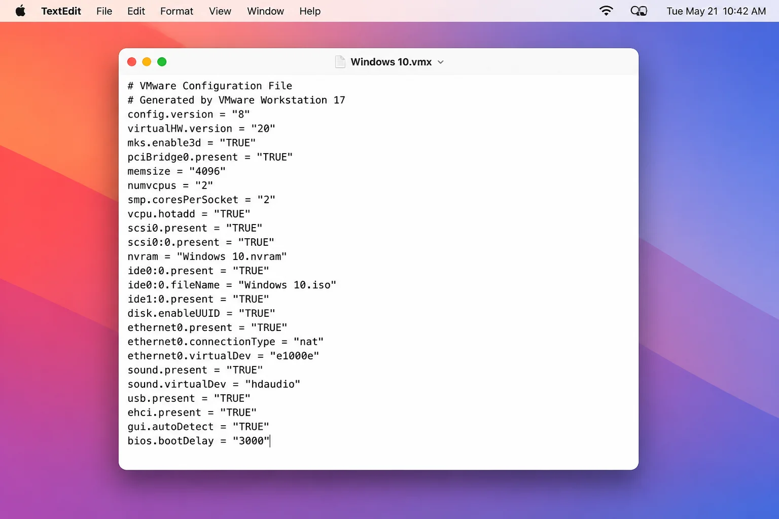 A .vmx config file open in TextEdit with the line bios.bootDelay = "3000" added at the bottom of the file, with other