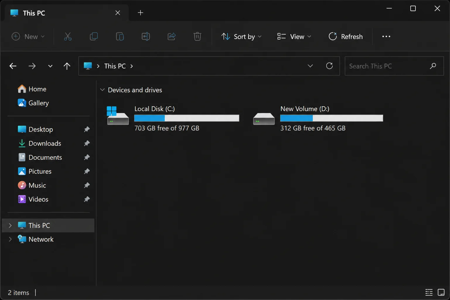 Windows 11 File Explorer showing "This PC" with an additional drive letter representing the newly attached old hard drive, appearing alongside the host PC's existing local drives