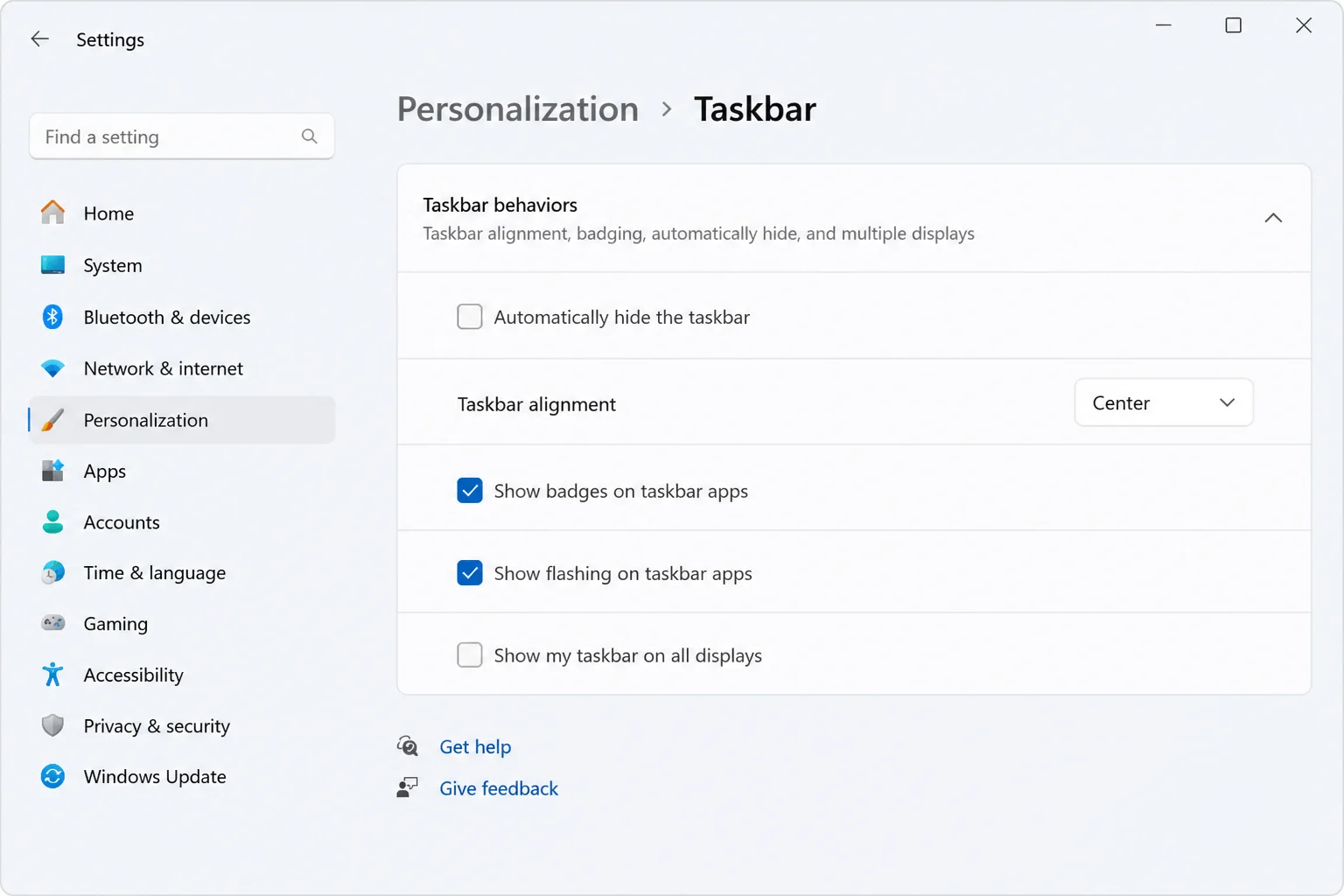 Windows 11 Settings > Personalization > Taskbar > Taskbar behaviors section with "Automatically hide the taskbar" unchecked