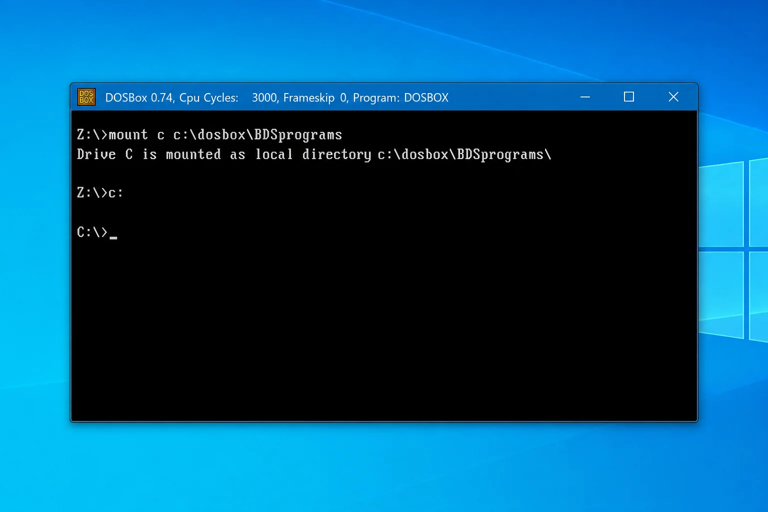 DOSBox window showing the MOUNT command typed at the Z:\ prompt, with the success message "Drive C is mounted as local directory" visible