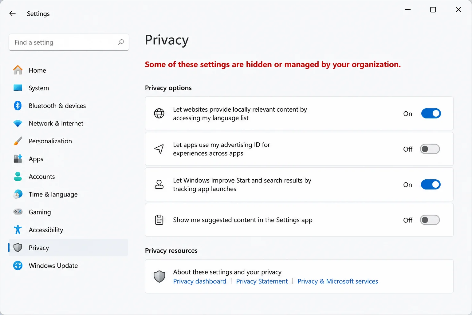 Windows Settings showing a stable managed-by-your-organization message with the message highlighted and all organization and user information hidden