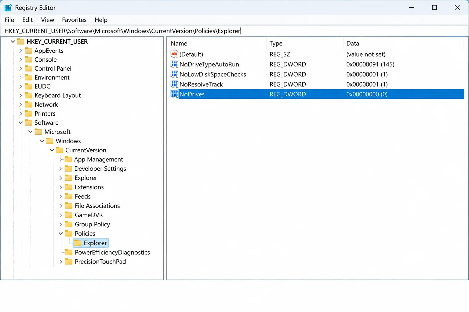 Registry Editor with the address bar showing HKEY_CURRENT_USER\Software\Microsoft\Windows\CurrentVersion\Policies\Explorer and the NoDrives DWORD value highlighted in the right pane